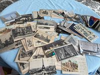 Spread of vintage postcards showing Eiffel Tower, architectural views, colour and monochrome prints