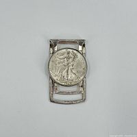 Front view showing 1945 Walking Liberty half dollar on clip