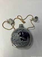 front view of ceramic flask with cups attached