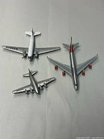 Three die-cast airplanes laid out showing overall size and designs