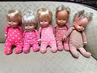 All five Drowsy dolls seated on sofa