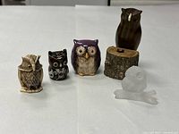 Front view of all five owl figurines in lot