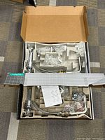 Box opened showing complete Hansgrohe faucet kit in molded tray