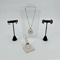 Group shot of necklace, ring, two earring pairs