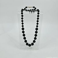 Full view of onyx graduated bead necklace on stand