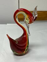 front view of red and green glass bird figurine