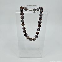 Full view of Pietersite bead necklace on stand