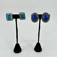 Both pairs of sterling silver stone earrings on stands