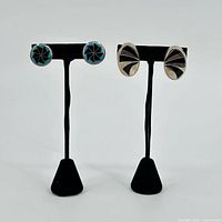 Both earring pairs on stands, overview of lot