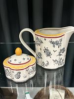 pitcher and lidded jar front view