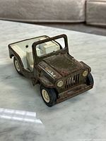 Front three-quarter view showing Tonka logo, paint wear, wheels