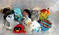 Top view of bin showing eleven assorted plush toys