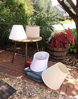 Group shot showing chair pads and multiple lamp shades outdoors