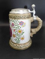 Side view of Gerz beer stein showing floral decoration, handle and pewter lid