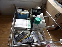 Overall view of chrome wire basket with assorted supplies