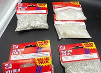 Overview of four sealed bead packs showing Westrim Crafts and generic clear bead bag