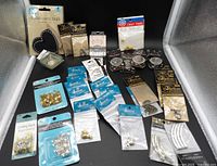 All sealed packs of findings, beads, chalkboard tags and trim displayed