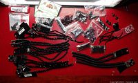 All items laid out on red surface showing strands, bags, focal bead