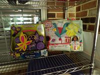 Boombox and dress-up set on shelf, full view