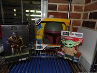 All three sealed Star Wars items on shelving