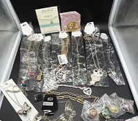 Overview of bagged and carded fashion necklaces laid out
