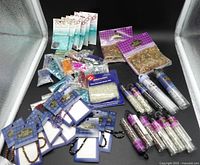 Entire assortment of packaged strands, tubes and bags of beads on black background