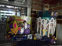 Both sealed items on shelf: Encanto boombox and Wish Rosas Castle playset