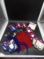 All fifteen packages of red, white and blue glass beads displayed