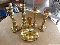 All four candlesticks and wall sconce displayed