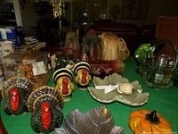 overview of assorted Thanksgiving décor on green surface