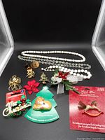 Full lot overview showing necklaces, bracelet, copper brooch and earrings, multiple holiday pins