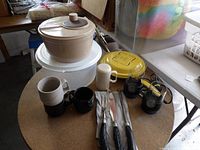 Group shot: cake keeper, salad spinner, mugs, shaker, knives, yellow lid