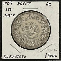Reverse view showing denomination, wreath, dual dates, silver tone