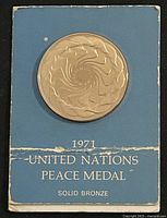 Medal on blue card, front view