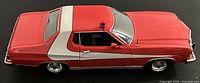 Left side and roof view of red and white 1976 Ford Gran Torino die-cast model