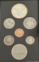 Obverse sides of seven proof coins in case