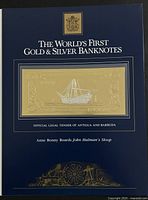 Front cover of presentation folder titled World's First Gold & Silver Banknotes