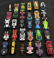 Top-down view of all 30 Hot Wheels vehicles arranged in rows
