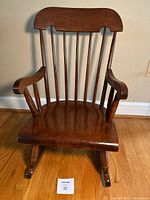 Front view of wooden child’s rocking chair