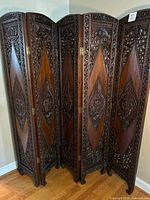 Full view of folded five-panel carved wood divider