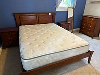 Bed frame assembled with mattress, both nightstands, dresser, and mirror visible