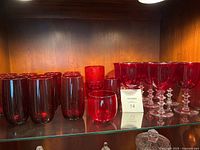 Shelf showing ruby red tumblers, small juice glasses and stemmed goblets