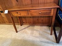 Full view of wooden console table front, two drawers visible