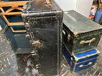 Three trunks grouped together, showing relative sizes, colors, and exterior condition