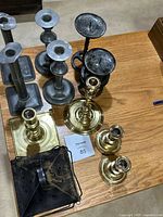 Group view of all candlesticks and lantern on table