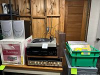 Front view showing turntable, cassette deck, receiver, Advent speaker boxes, small speakers, and crate of vinyl records