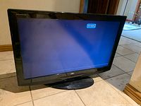 Front view of AOC 27-inch TV on stand