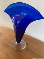 Full view of cobalt blue flared vase on table