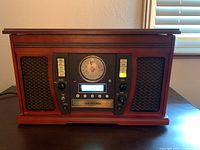 Front view of Crosley unit showing speaker grilles, controls and wood finish