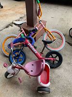 Group view of Strider bike, Huffy bike, Radio Flyer tricycle